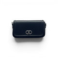 COC Store black faux leather shoulder bag with silver interlocking CD clasp and adjustable strap.