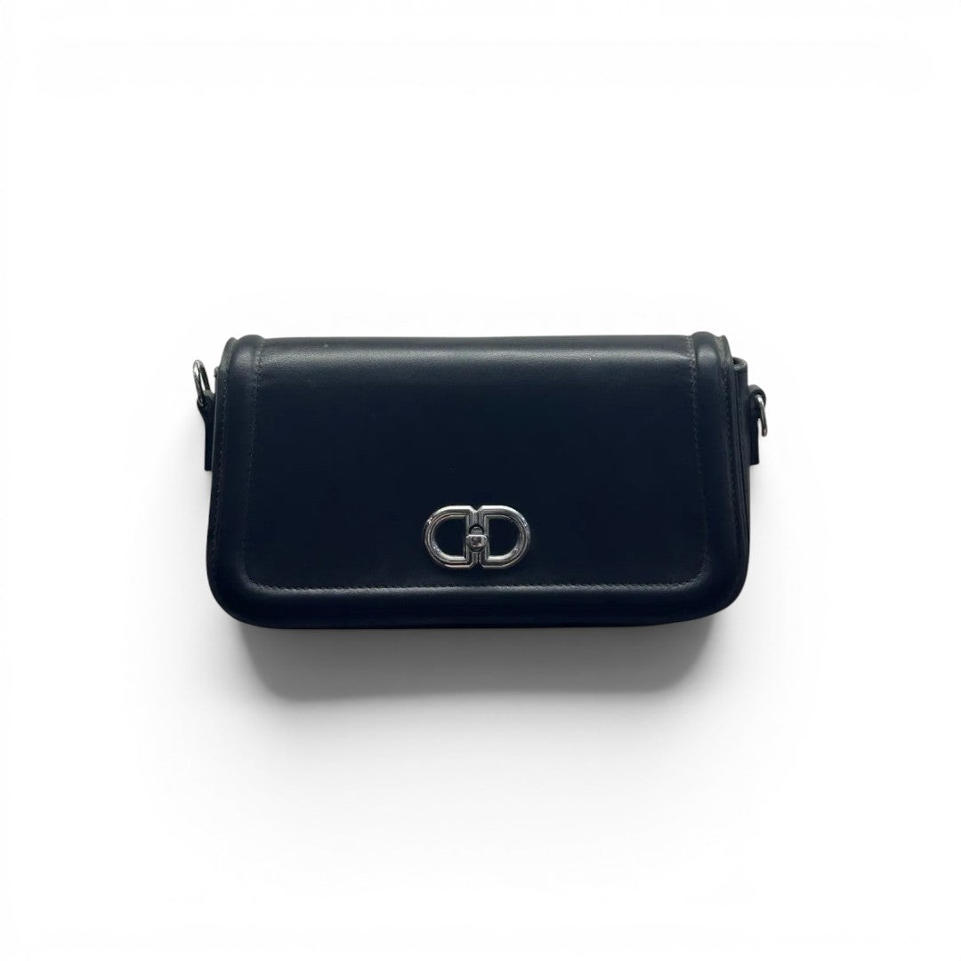 COC Store black faux leather shoulder bag with silver interlocking CD clasp and adjustable strap.