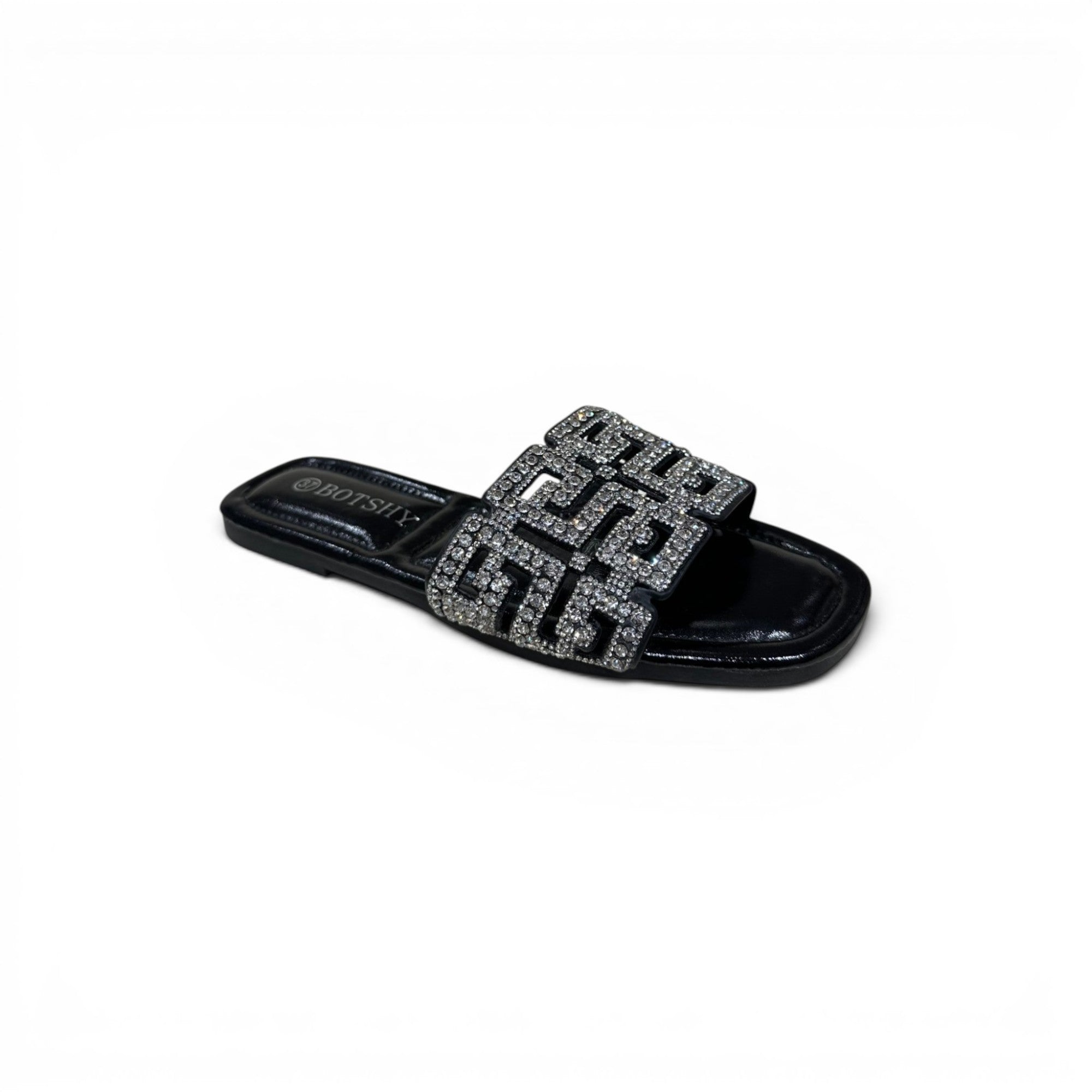 COC Store black slide sandals with geometric rhinestone embellished strap. Flat sole, slip-on design.