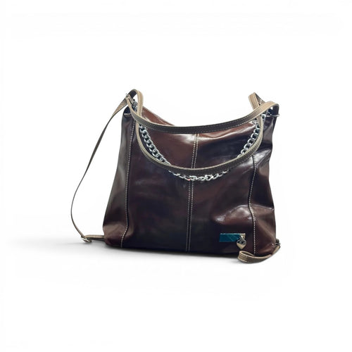 COC Store brown glossy faux leather shoulder bag with tan straps, white stitching, and silver chain detail.