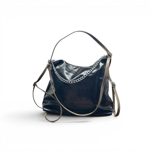 COC Store glossy faux leather shoulder bag in rich brown with tan straps, silver chain detail and adjustable strap.