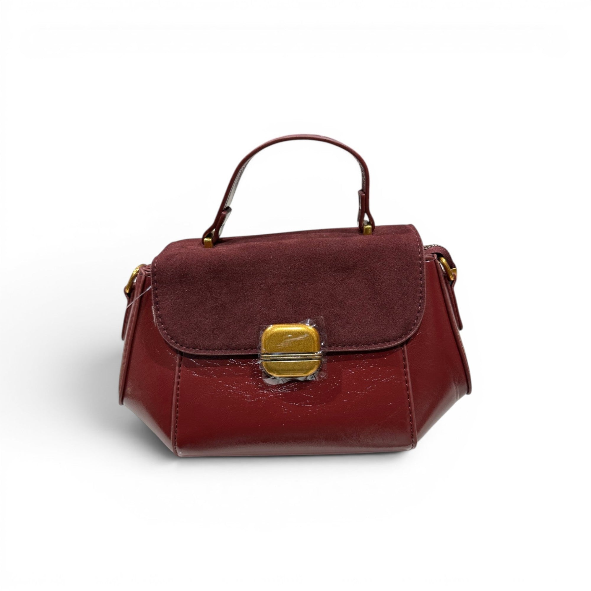 COC Store burgundy faux leather and suede satchel bag with gold clasp and top handle.