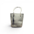 COC Store light grey textured faux leather bucket tote bag with top handles and decorative key charm.