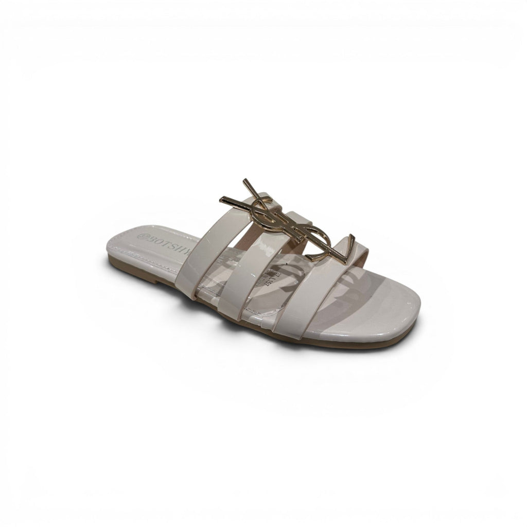 COC Store women's beige patent slide sandals with gold-tone interlocking buckle accent and multiple straps.