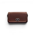 COC Store brown faux leather shoulder bag with silver-tone CD clasp and adjustable strap.