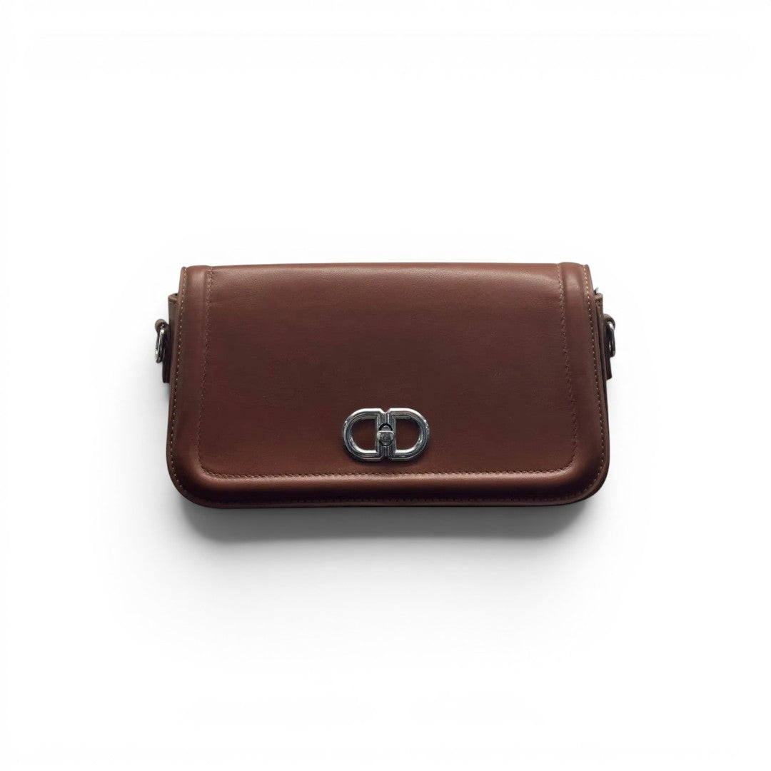 COC Store brown faux leather shoulder bag with silver-tone CD clasp and adjustable strap.